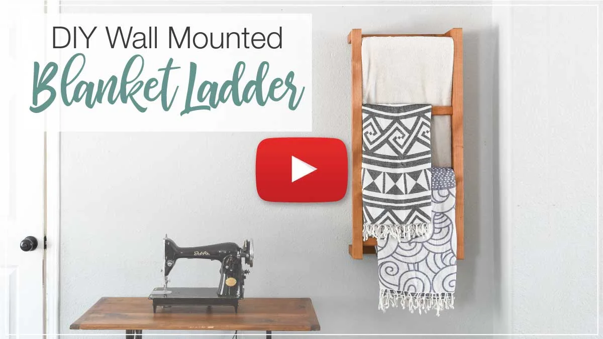 YouTube thumbnail with play button for DIY Wall Mounted Blanket Ladder video.