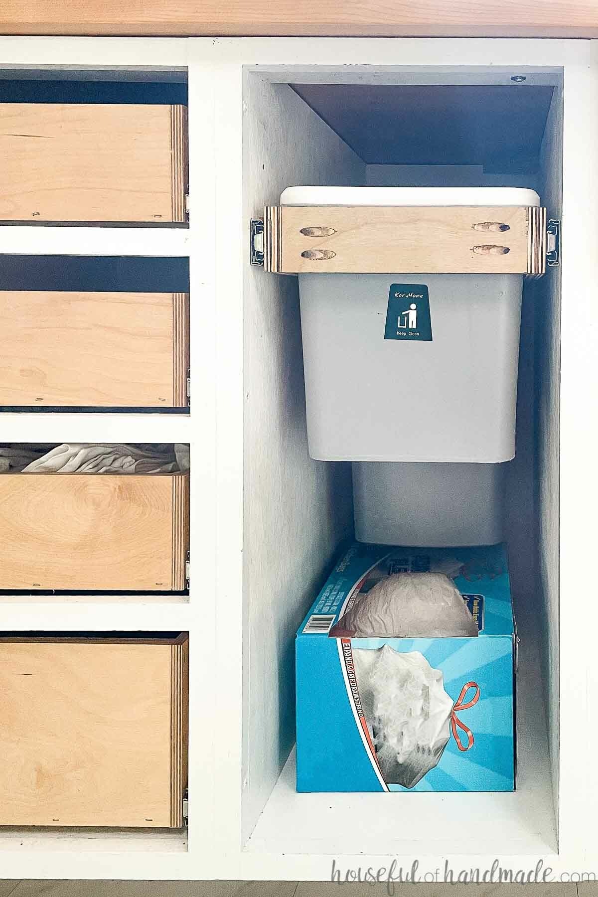 DIY kitchen remodel with a garbage can cabinet holding a trash can and compost bin with room below for a box of trash bags. 