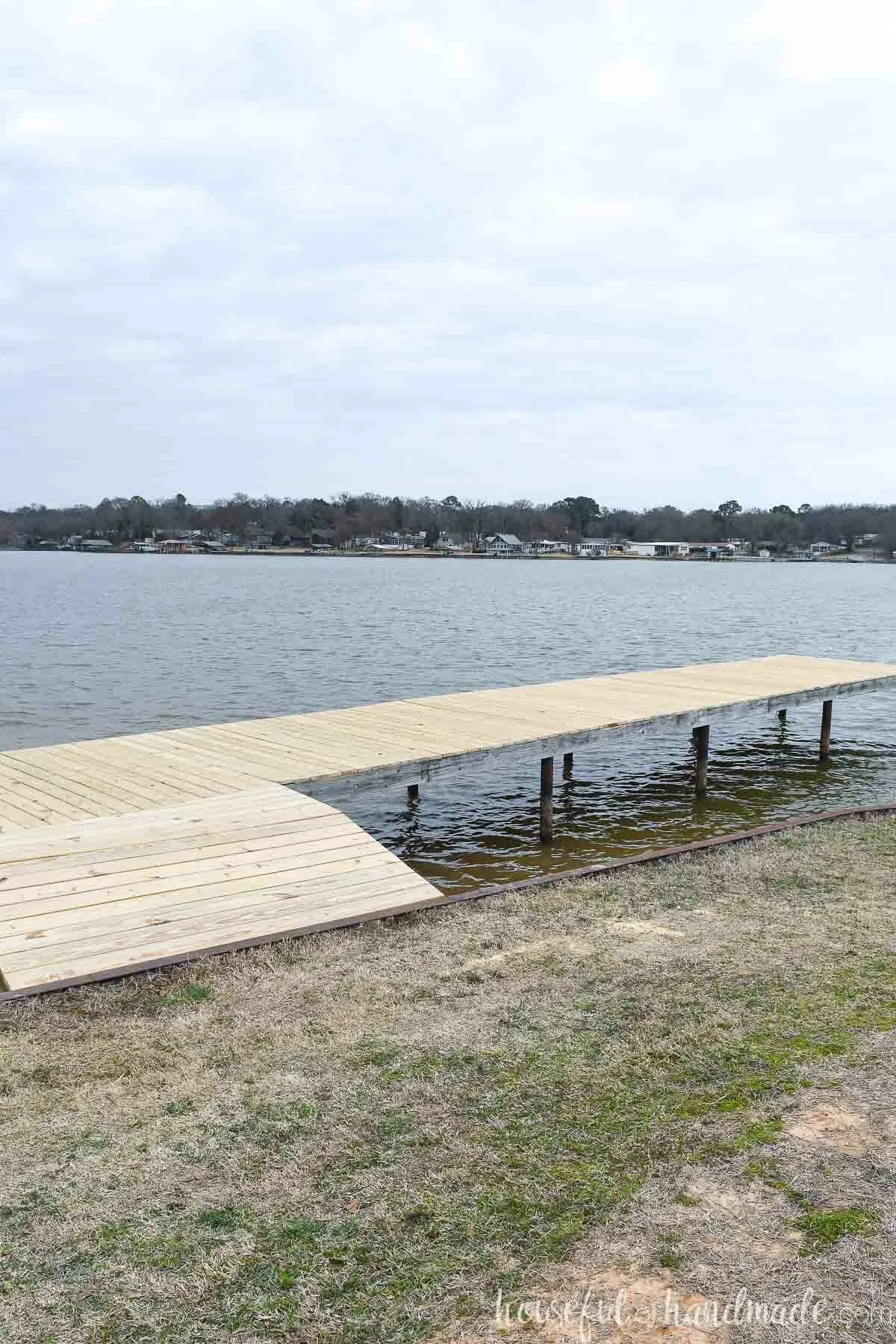 Lake dock with newly replaced deck board on top. 
