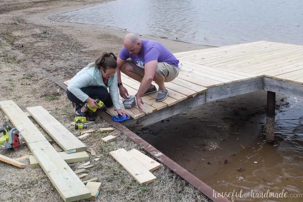 Attaching the final deck board on the updated dock. 