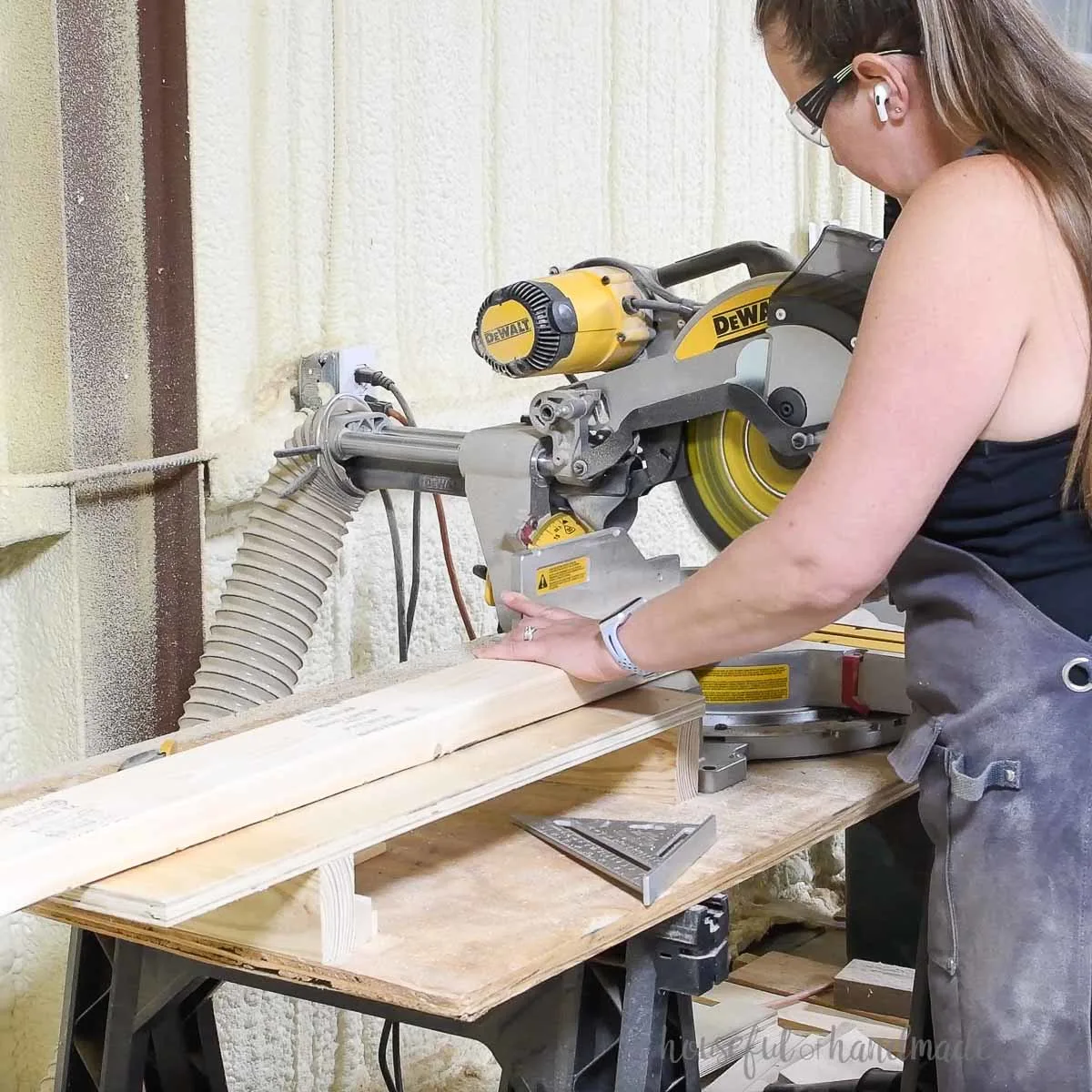 Cutting 2x4 boards on a miter saw.
