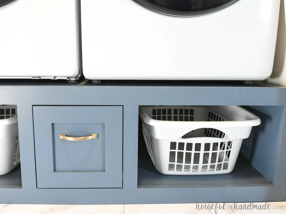 Straight on view of the navy blue washer platform holding the washer and dryer. 