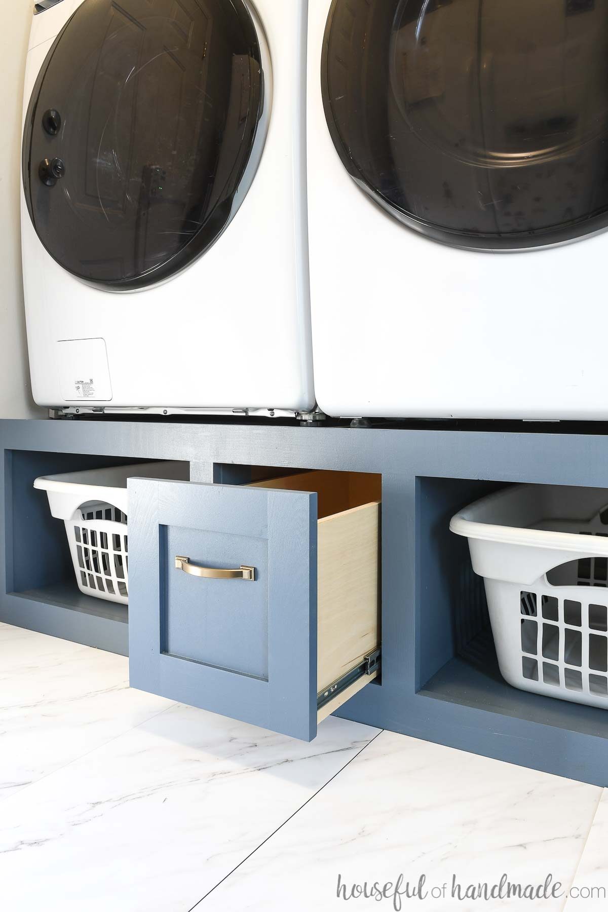 Washer and dryer platform with a drawer and shelves for storage. 