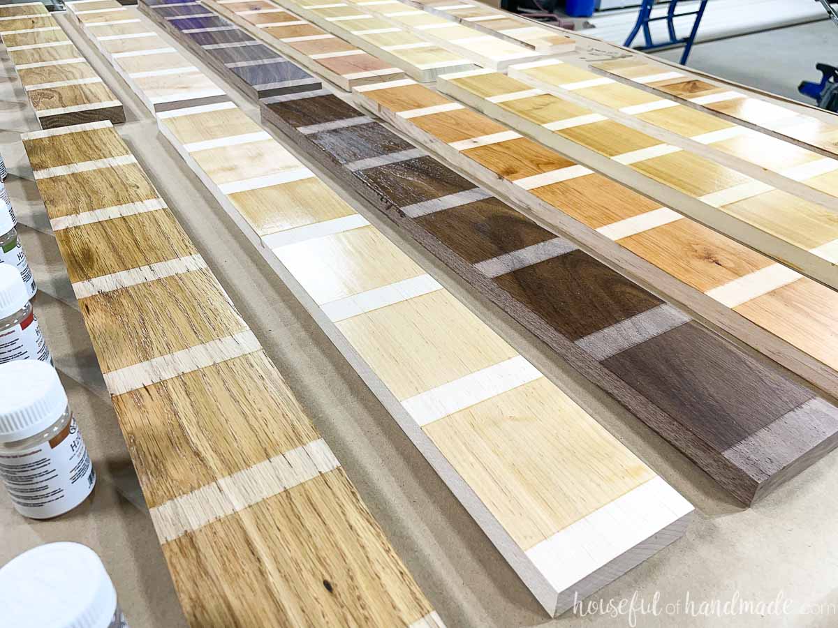 Boards of different wood species with samples of different finishes on them to compare the sheens. 