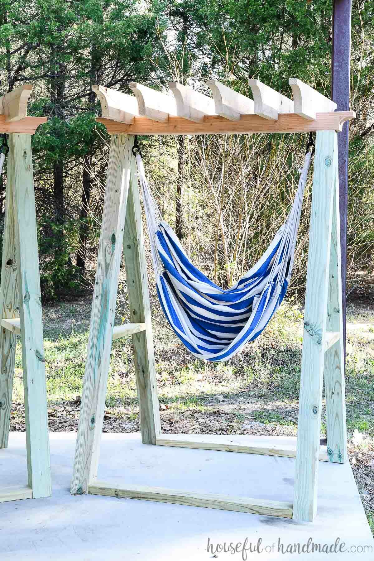 DIY hammock chair stand with blue and white striped hammock chair in it. 
