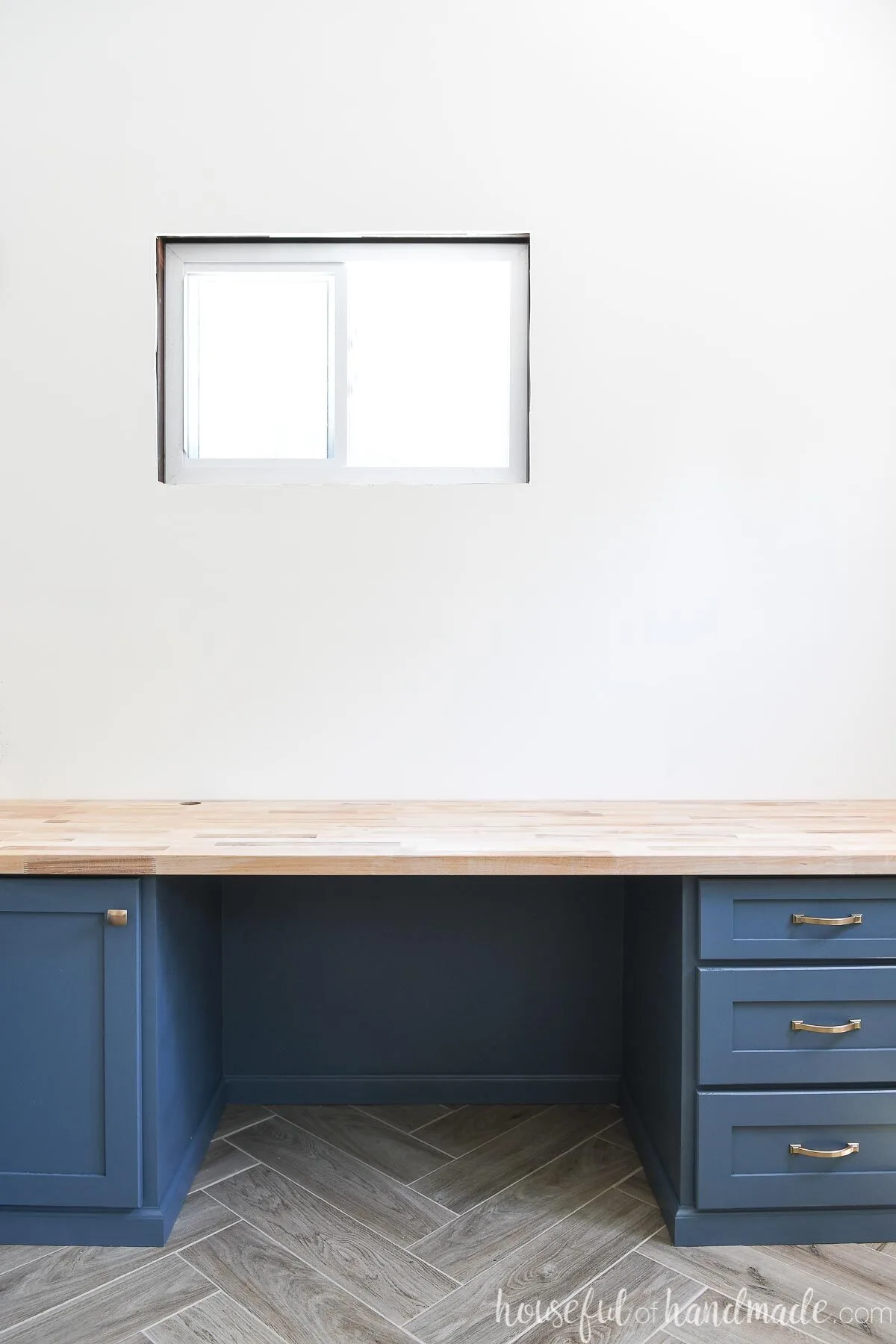 Built in desk painted NYPD blue with butcher block countertop on it. 