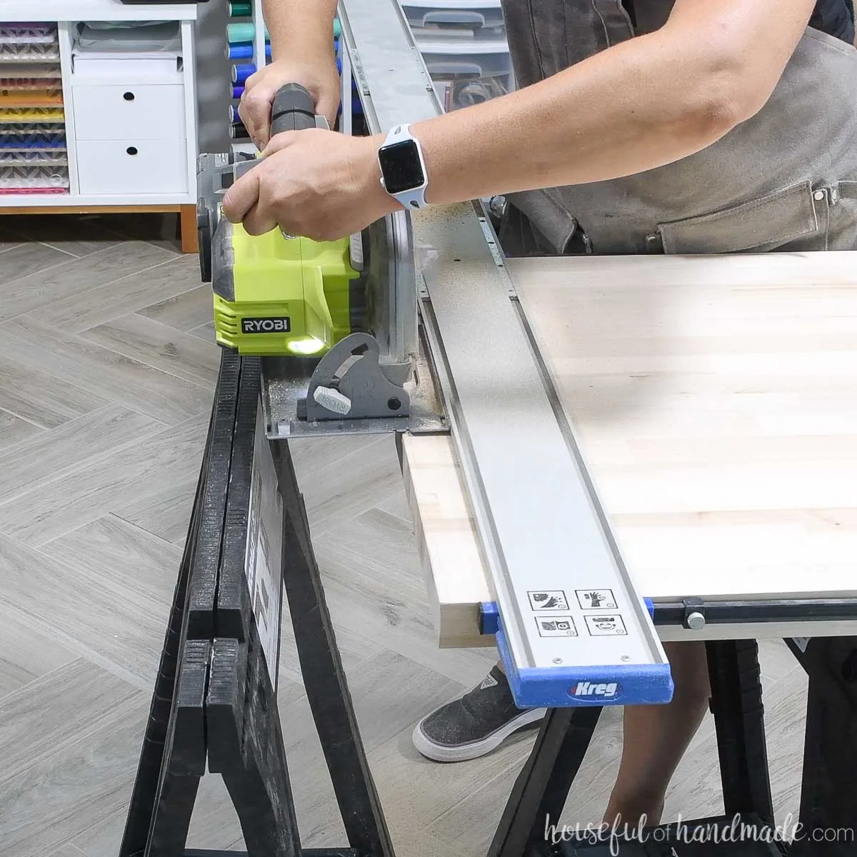 Cutting the curved edge off the butcher block countertop with a circular saw and guide track.