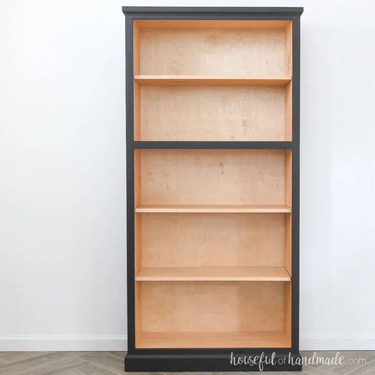 Bookcase with stained inside and black painted outside.