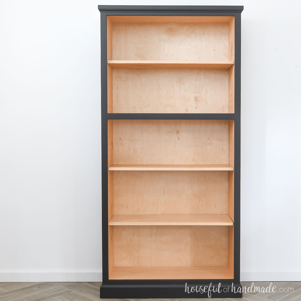 Bookcase with stained inside and black painted outside.