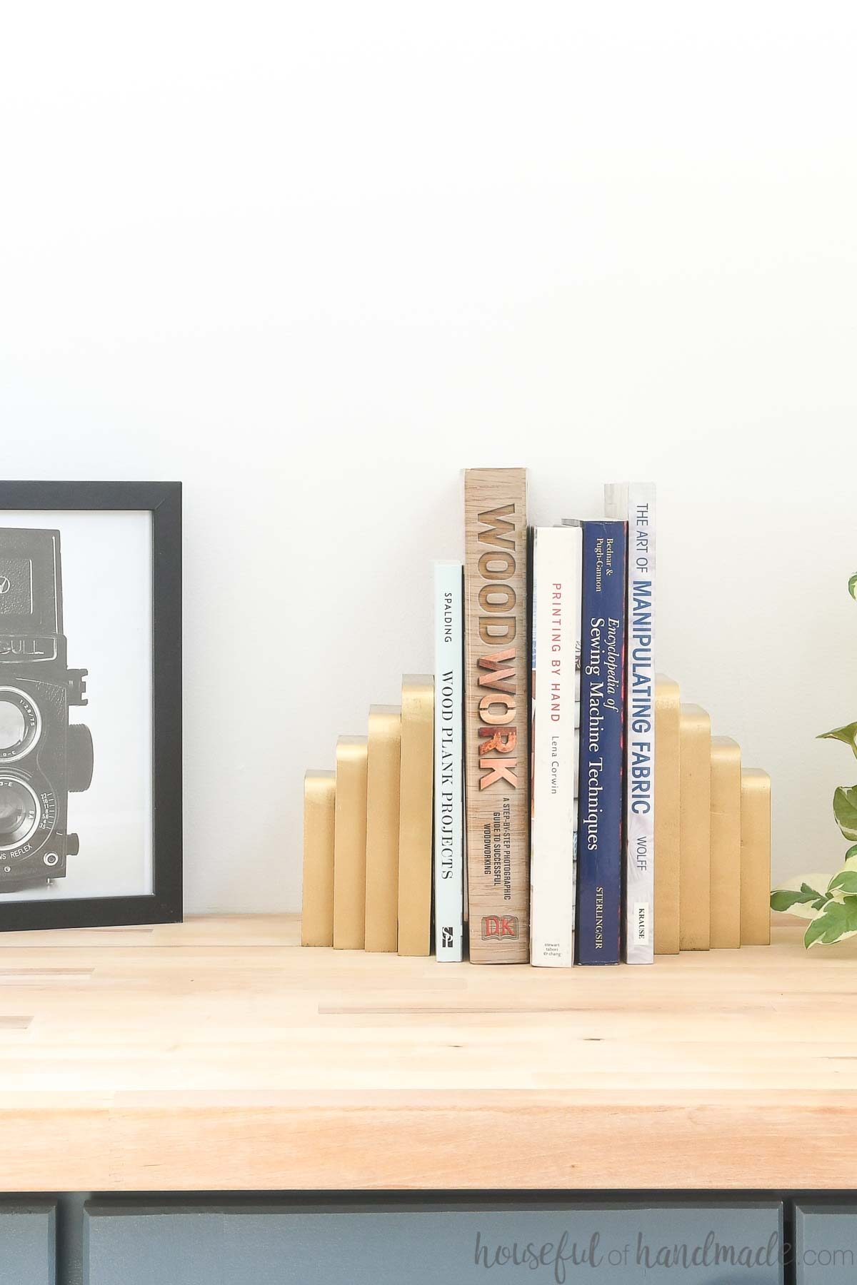 DIY bookends made from scrap wood spray painted to look like brass. 