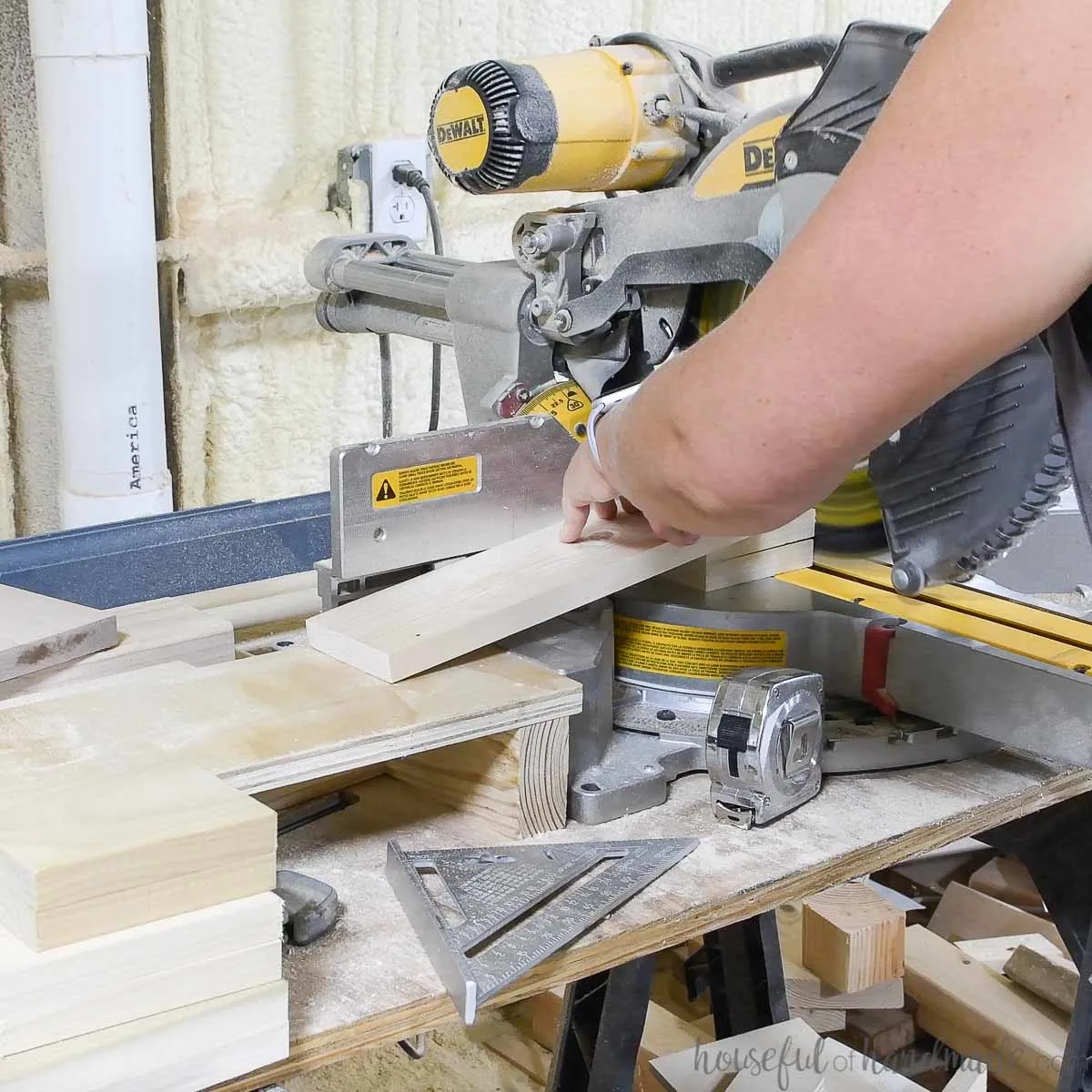 Cutting small pieces of scrap wood on a miter saw using another scrap piece to keep fingers safe. 