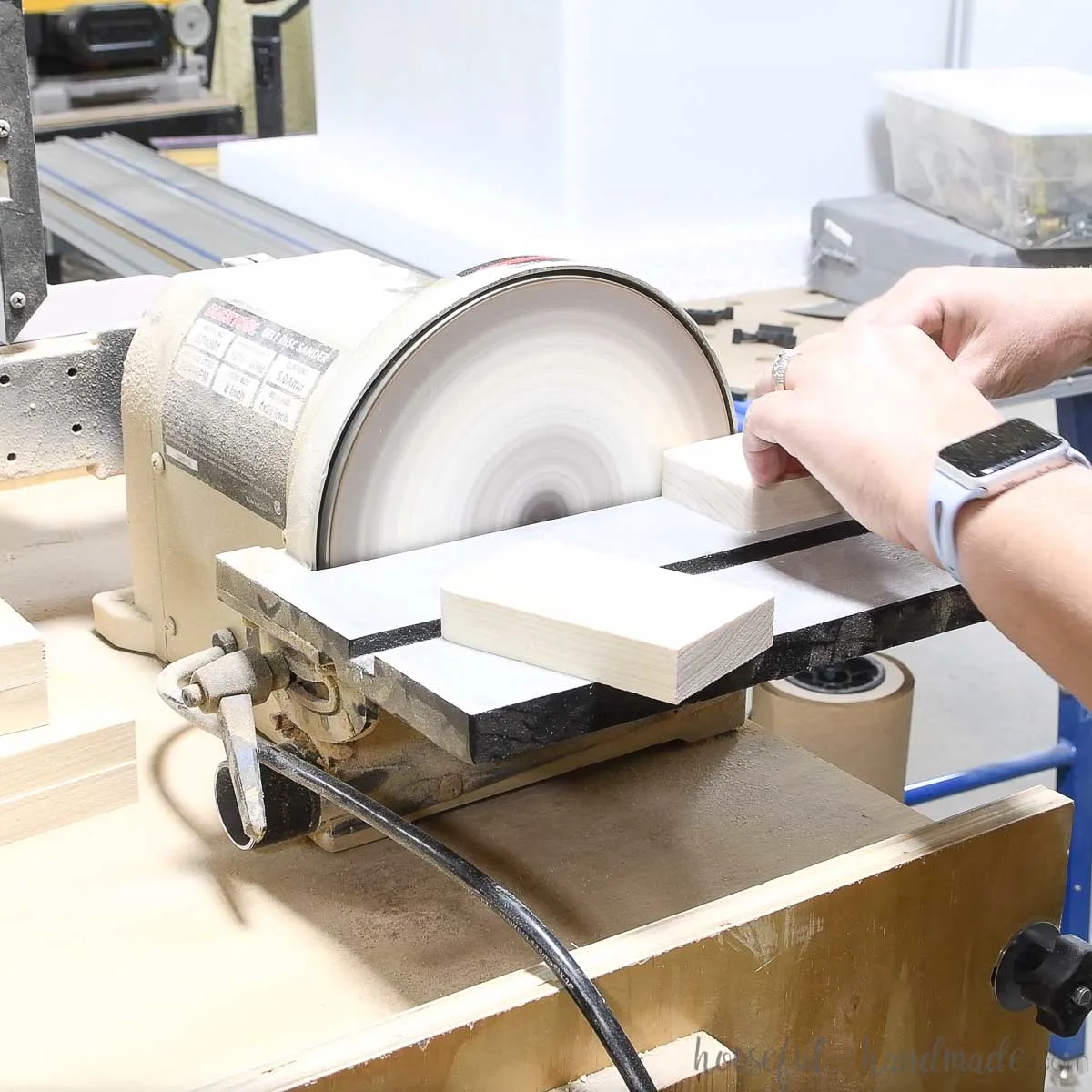 Using a disc sander to curve the top corners of all the pieces. 