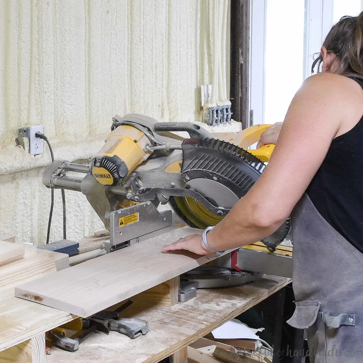 Cutting the boards for the DIY monitor stand on the miter saw. 