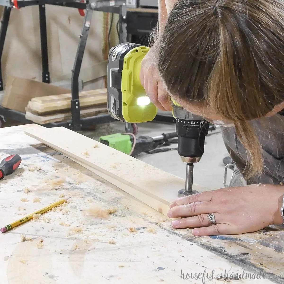 Drilling a hole in the center of the markings with a Forstner bit. 