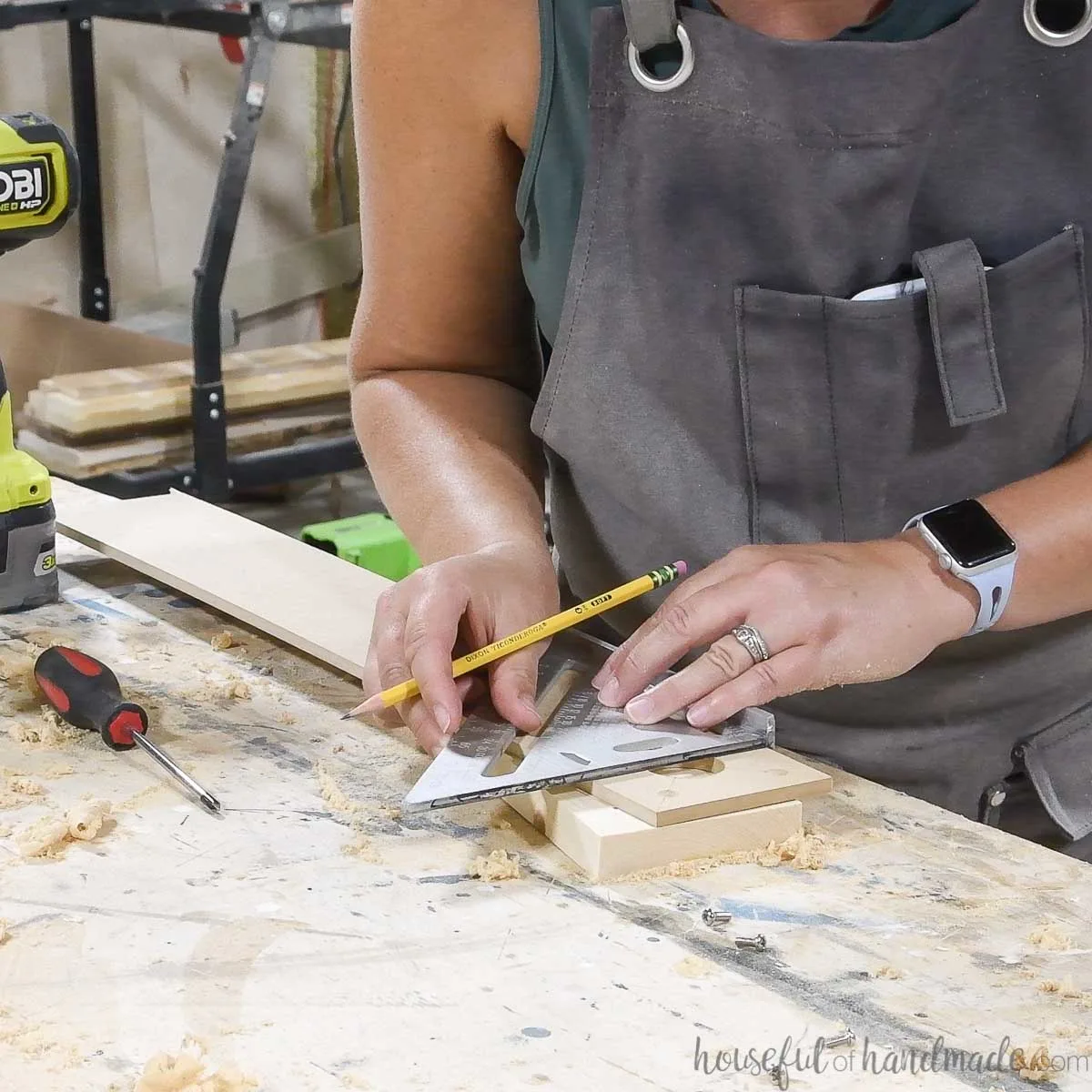 Marking the center of the router hole on the circle jig. 