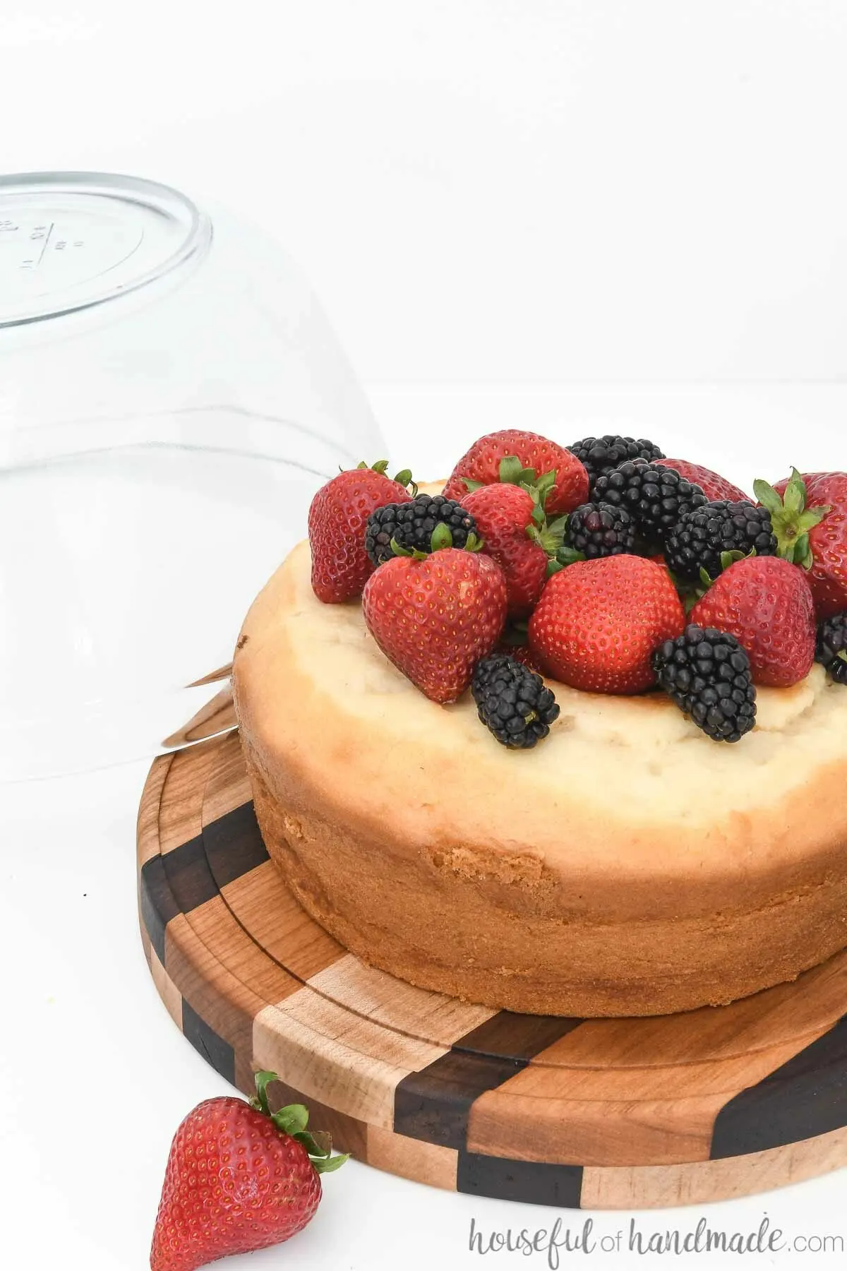 Round cake plate cut out with a router circle cutting jig showing the cake covered with berries.