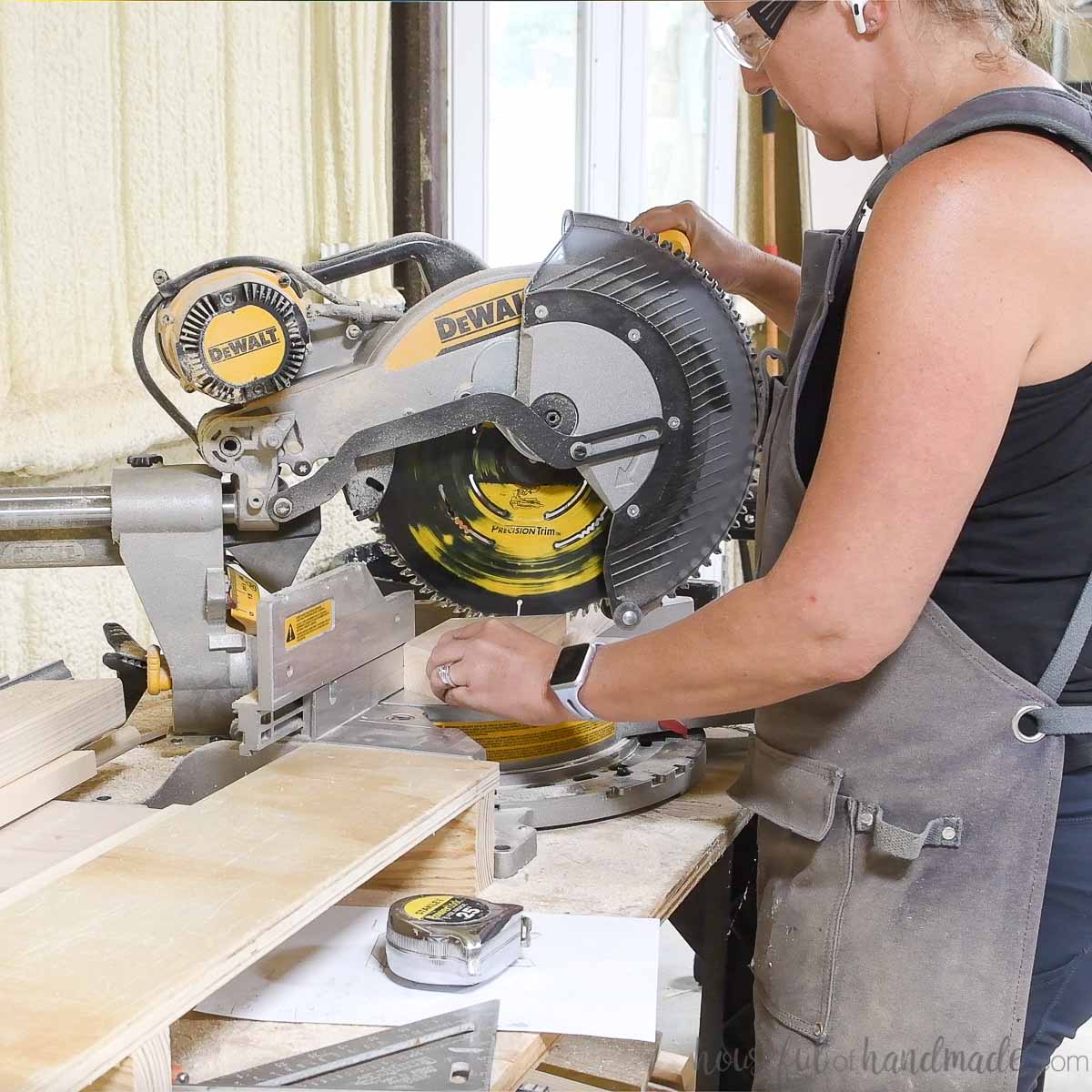 Cutting scrap wood pieces on a Dewalt miter saw. 