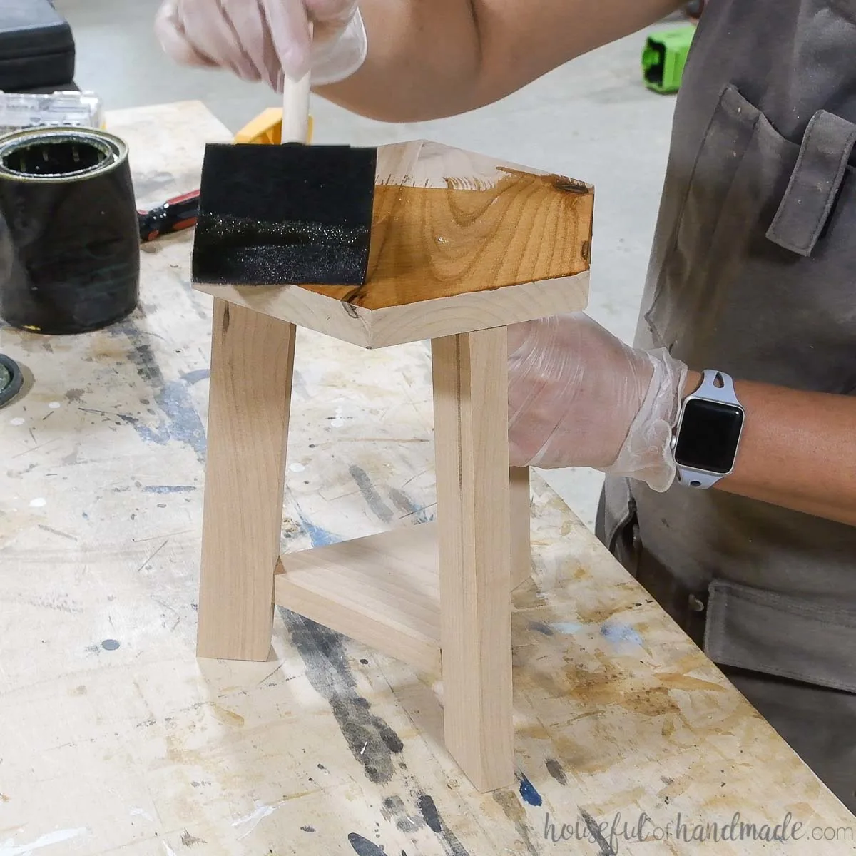 Adding sealer to the alder wood plant stool. 
