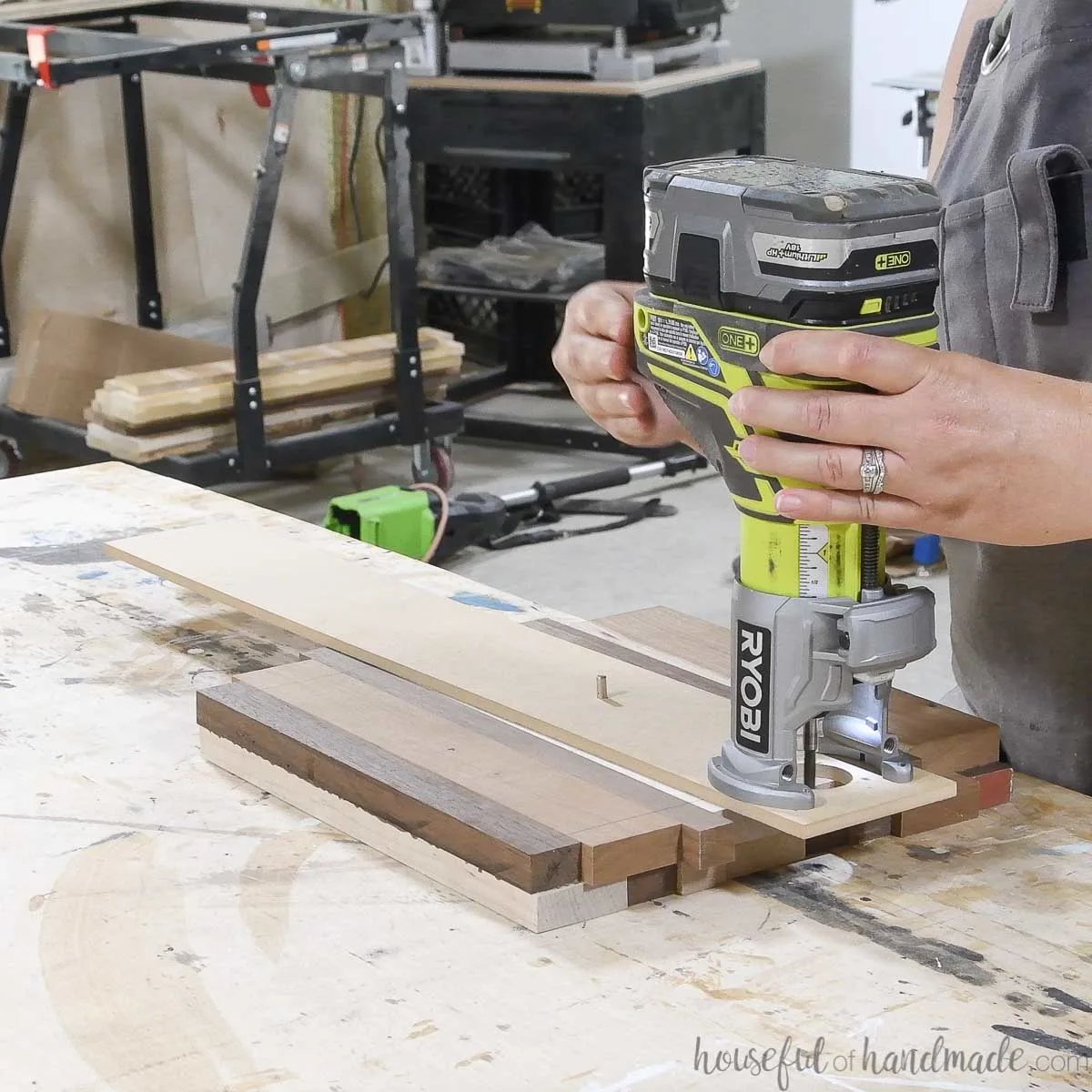 Router with circle jig attached to it on the wood cake plate piece. 