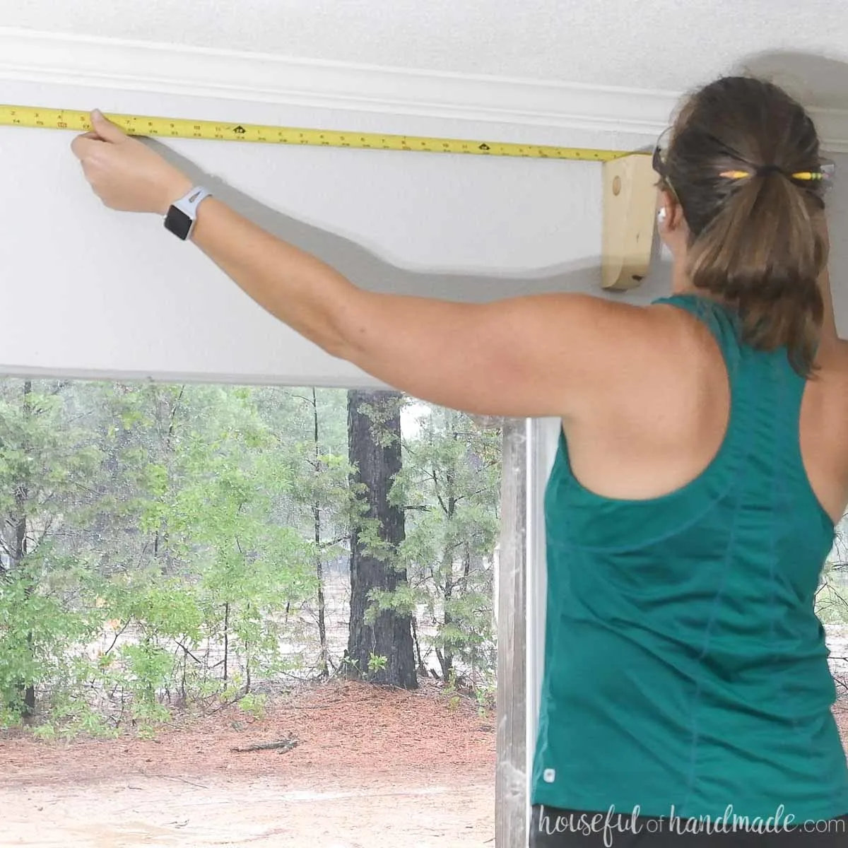 Measuring between curtain rod brackets for the length of the conduit. 