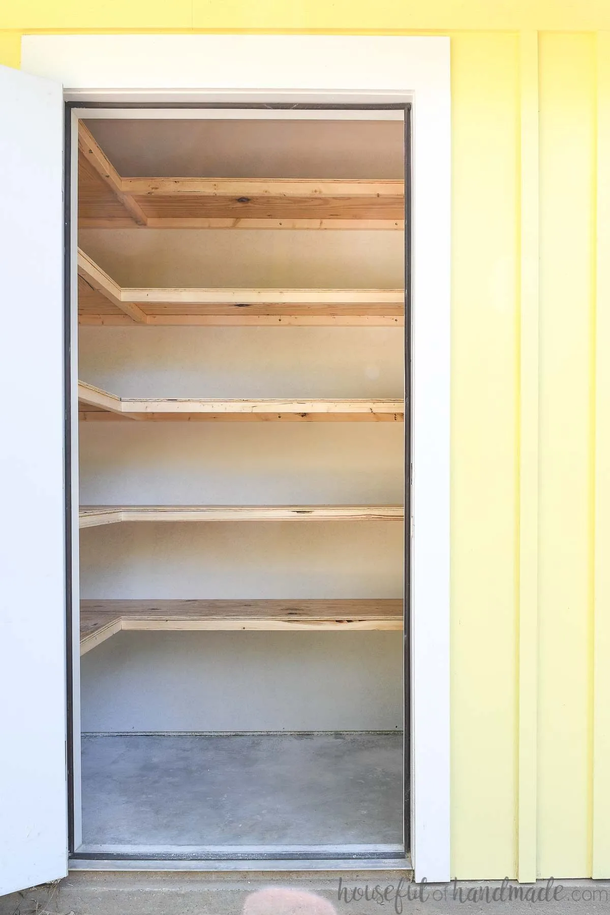 Storage closet with floating storage shelves built in it. 