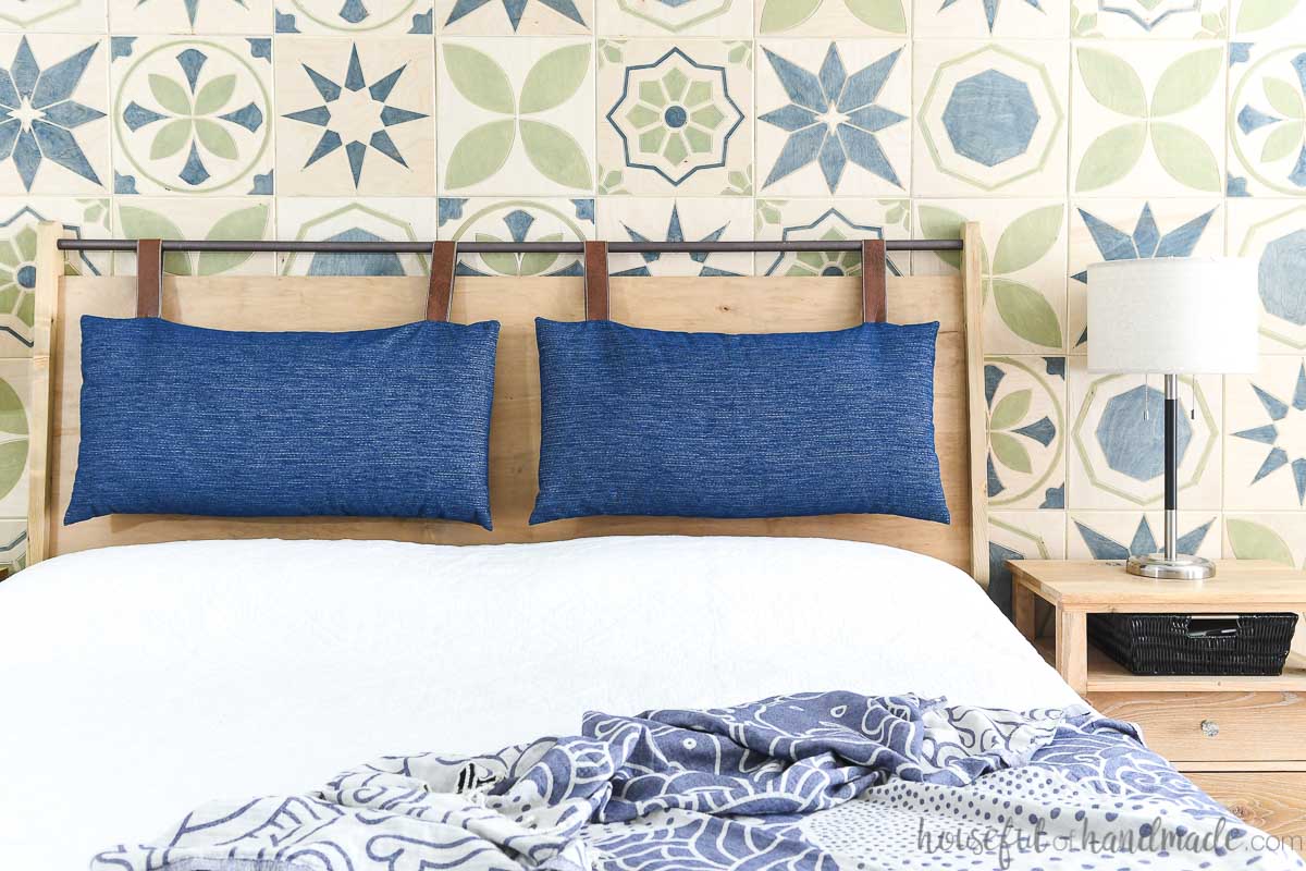 Front view of the modern headboard with blue hanging cushions. 