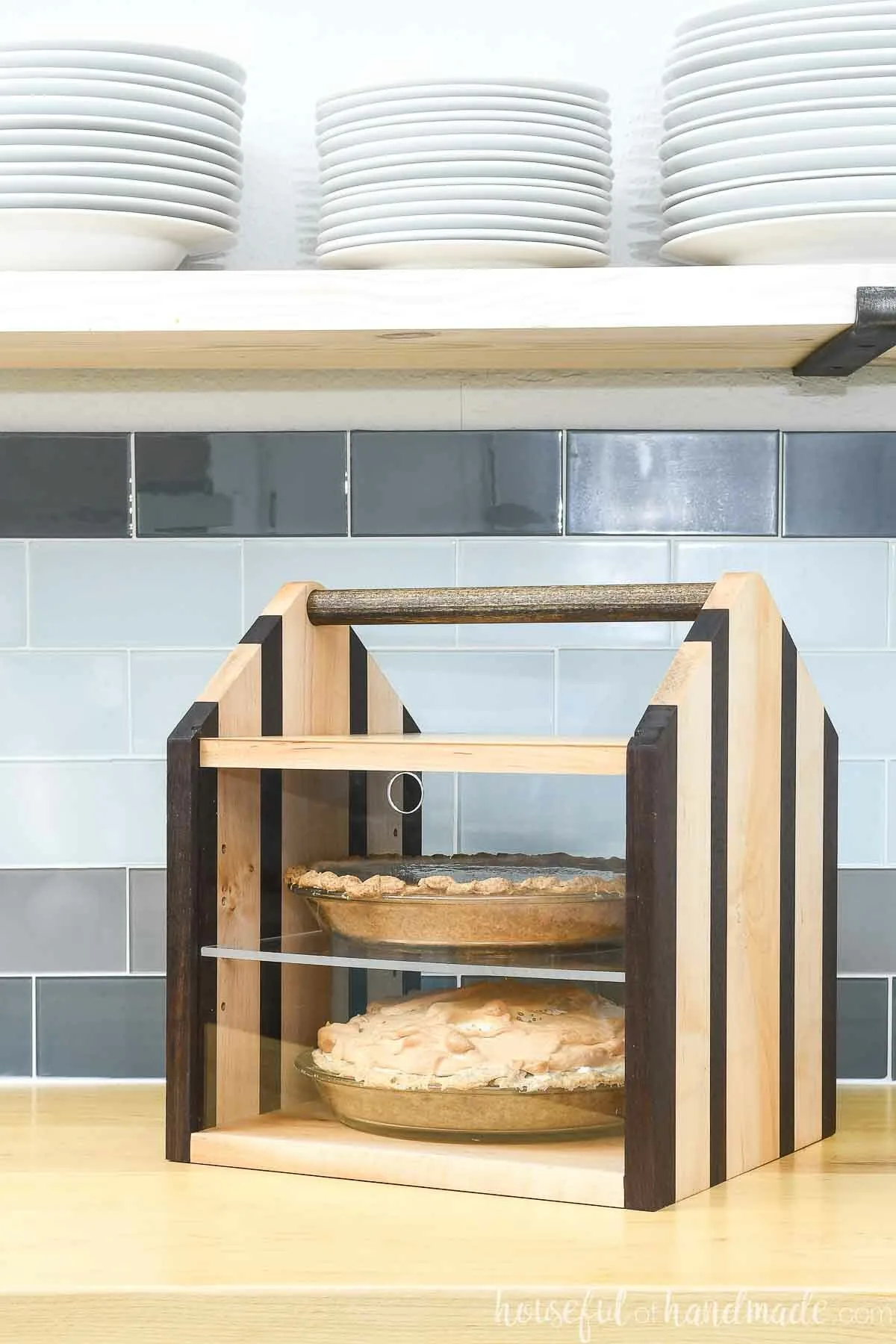 Maple and walnut double pie carrier with acrylic front with meringue and pumpkin pie inside.