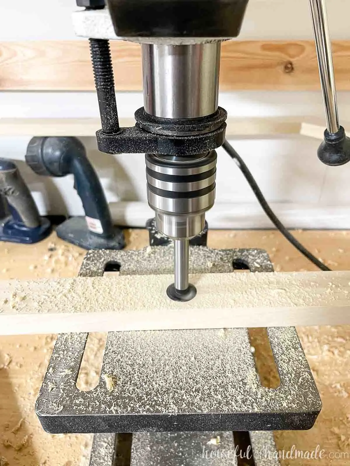 Drilling a hole in a 1x2 board on a drill press with a forstner bit. 