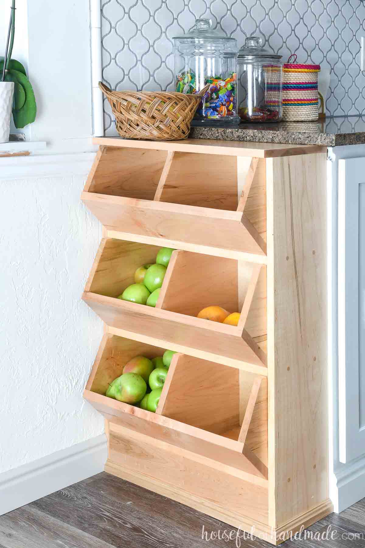 Six compartment wooden vegetable storage bins that fit at the end of a base cabinet. 