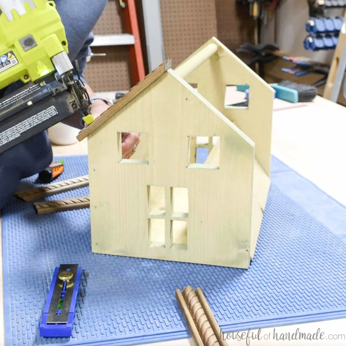 Nailing the roof pieces to the top of the dollhouse tote.