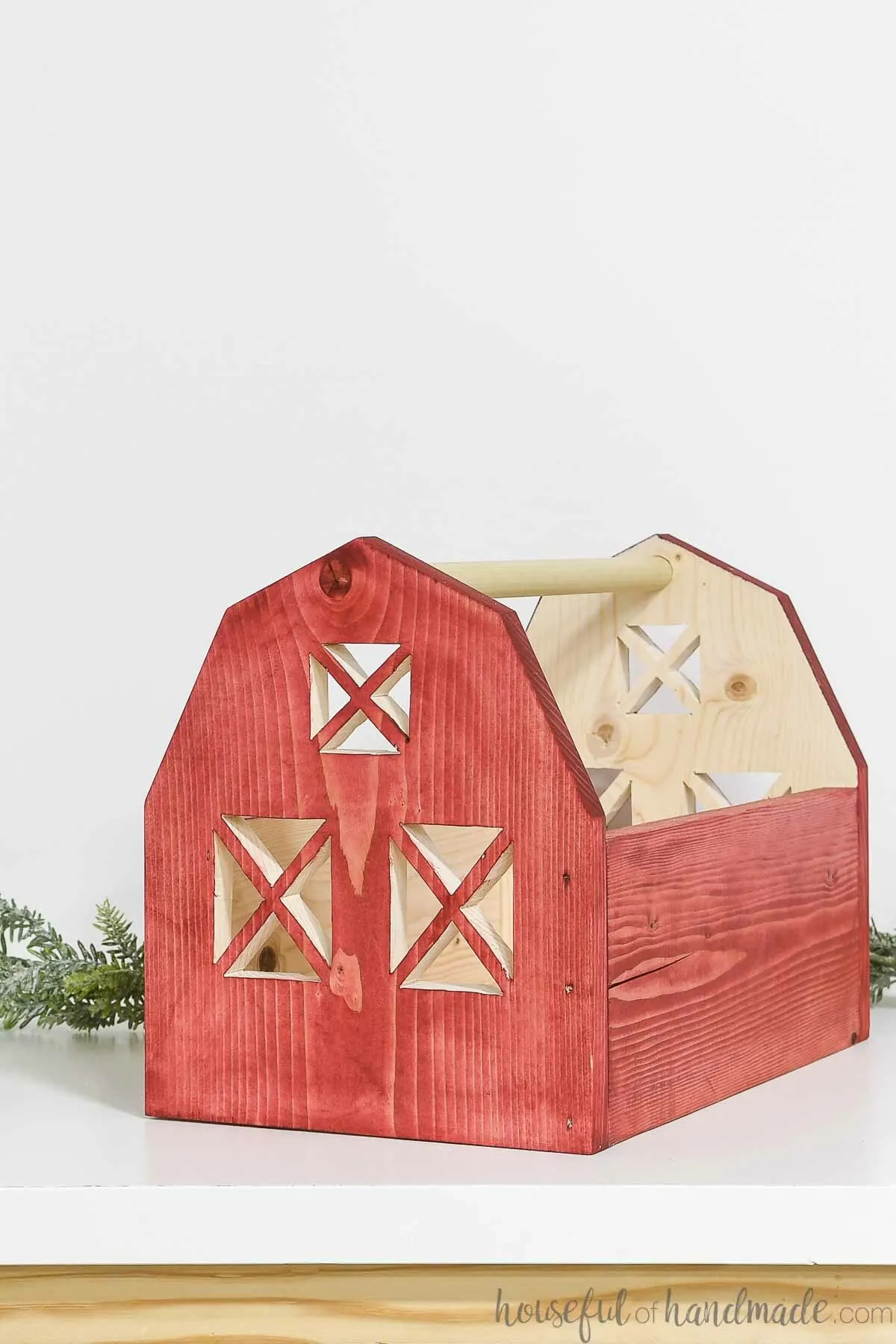 Wood toy barn with three sides and a handle on top to carry it around. 