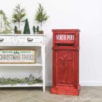 Red DIY Letters to Santa mailbox sitting next to a Christmas vignette.