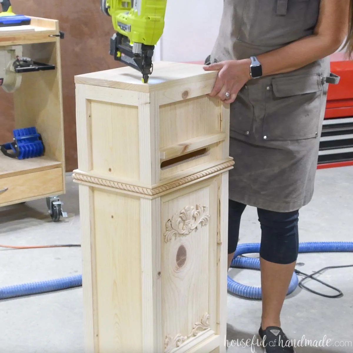 Attaching the top to the mailbox with a nailer. 