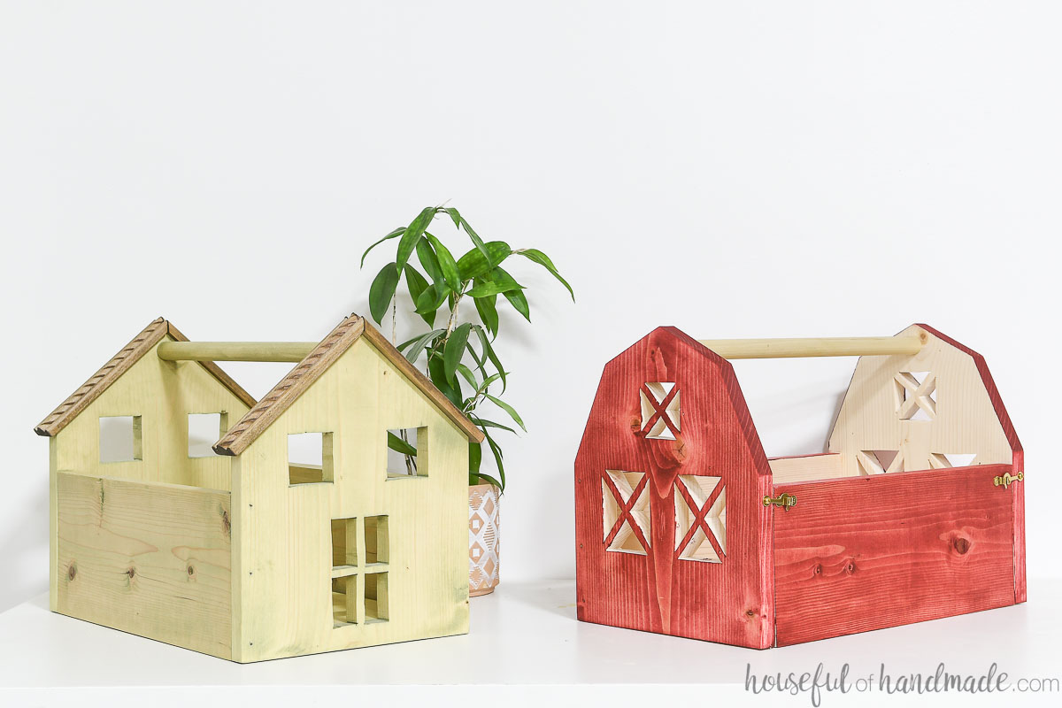 Portable wooden dollhouse and toy barn sitting next to each other on a table. 
