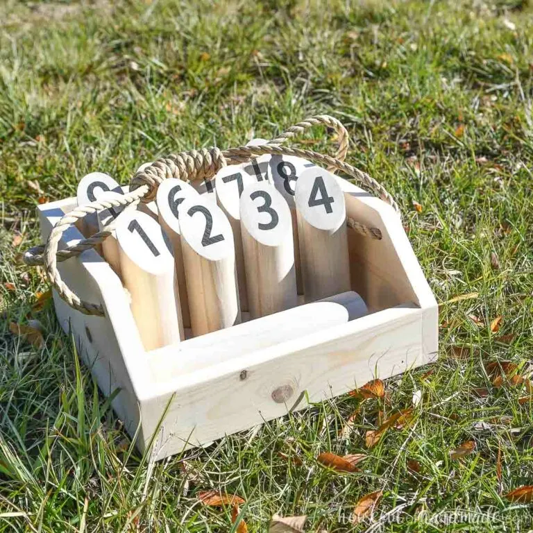 DIY Mölkky game in a carrier on the grass.