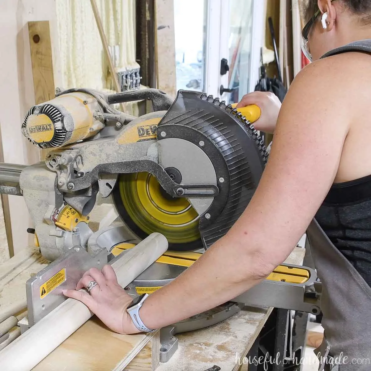 Cutting a large dowel on a miter saw. 