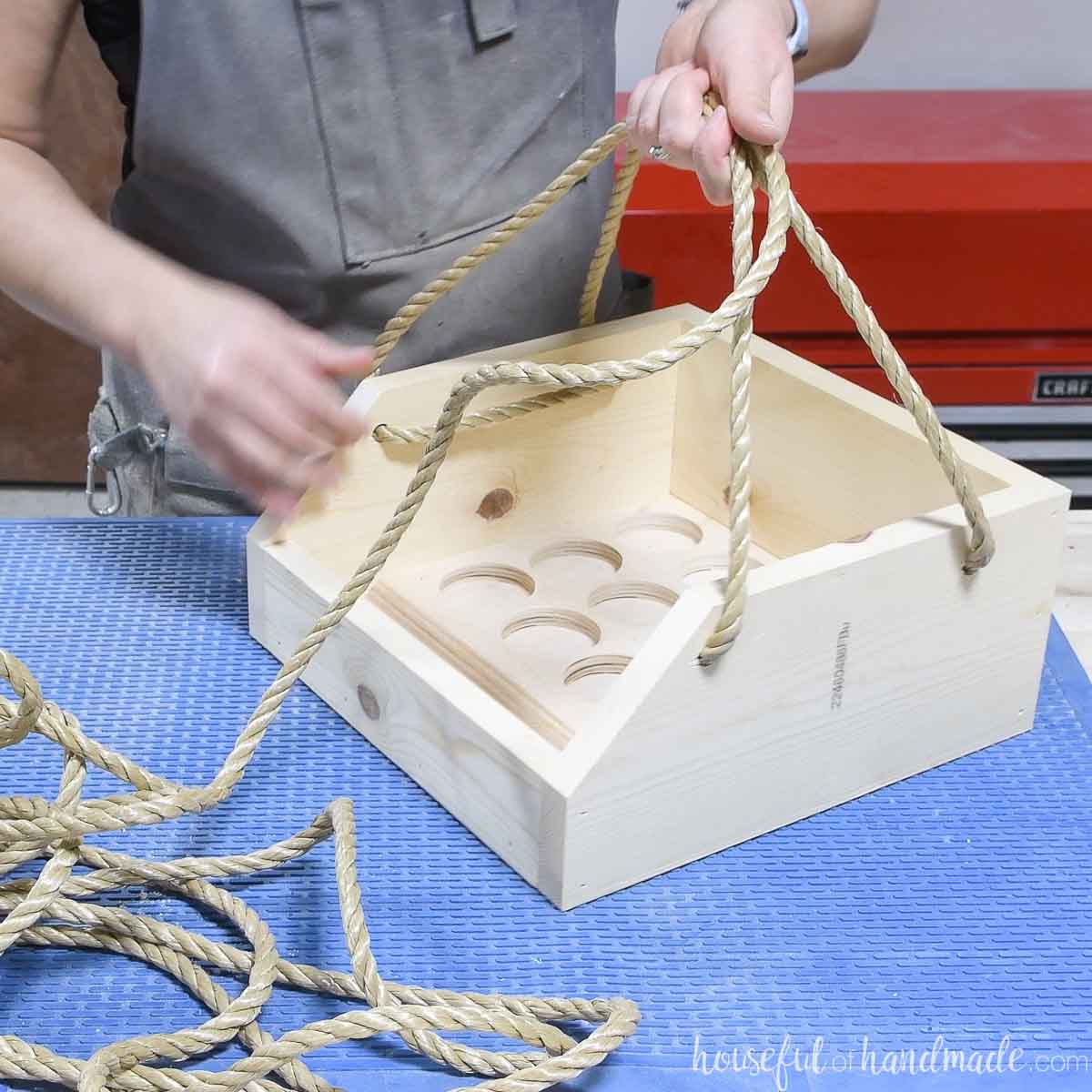 Creating a handle with rope through the holes in the side of the carrier. 