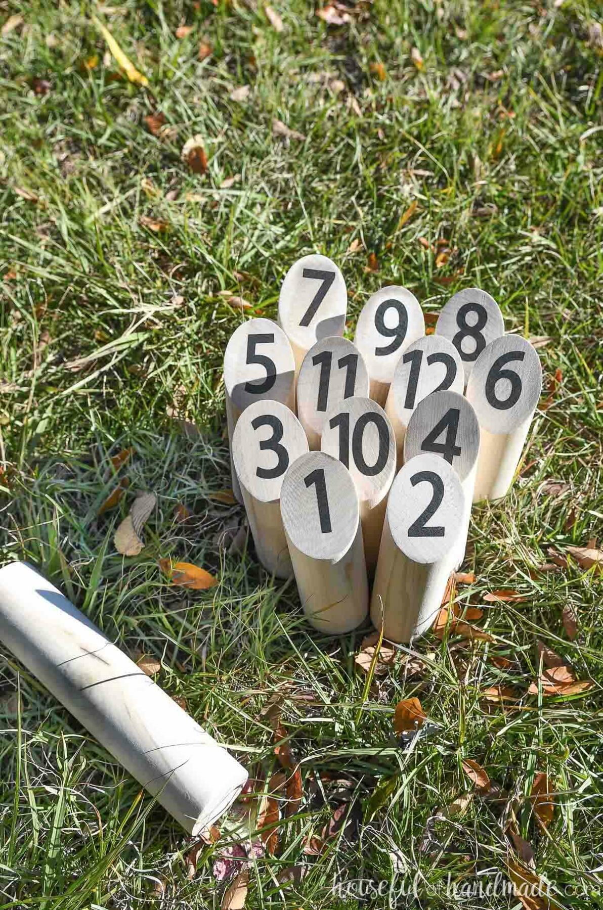 DIY Mölkky pins set up in the grass in the starting formation.