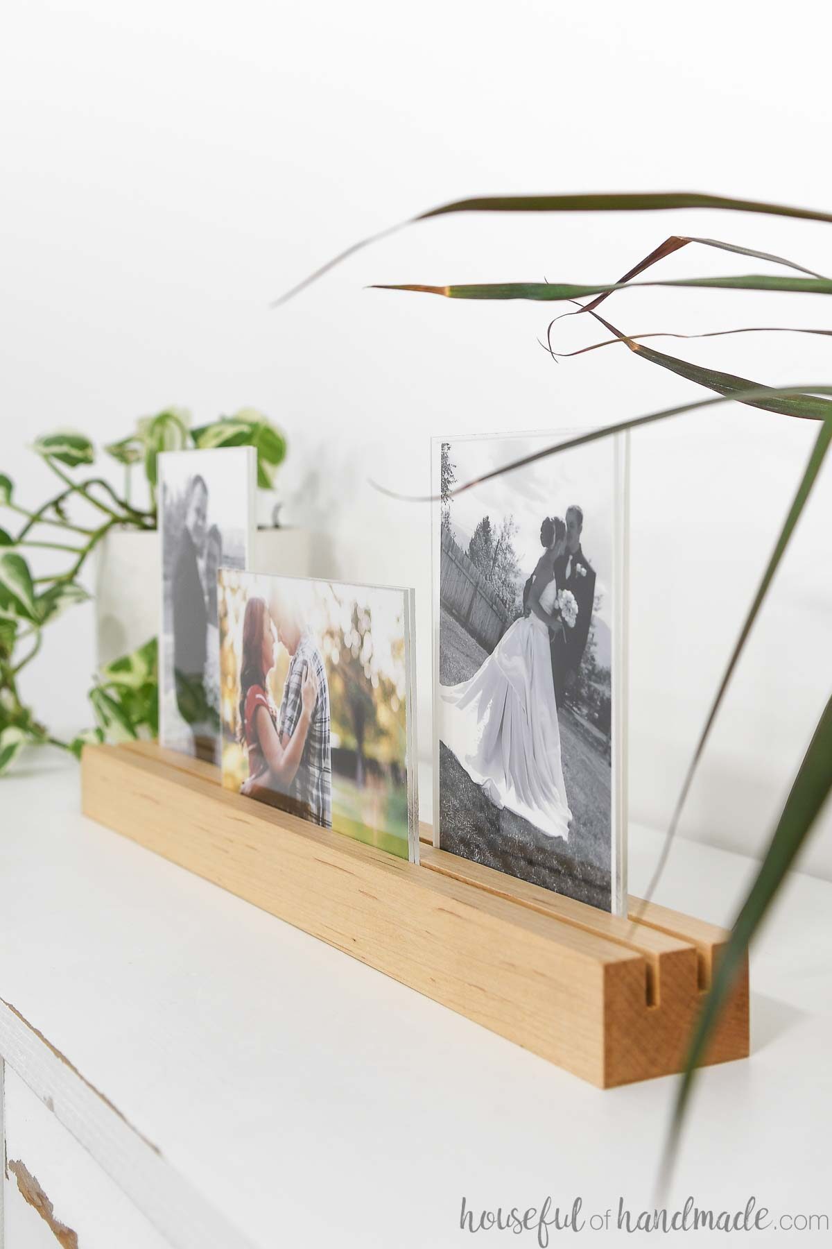 Artistic view of the picture frame holding 3 different photos in two rows. 