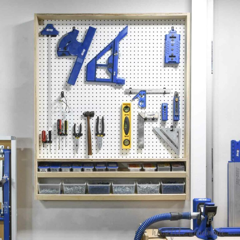 Pegboard storage organizer for tools and screws hanging on a wall.