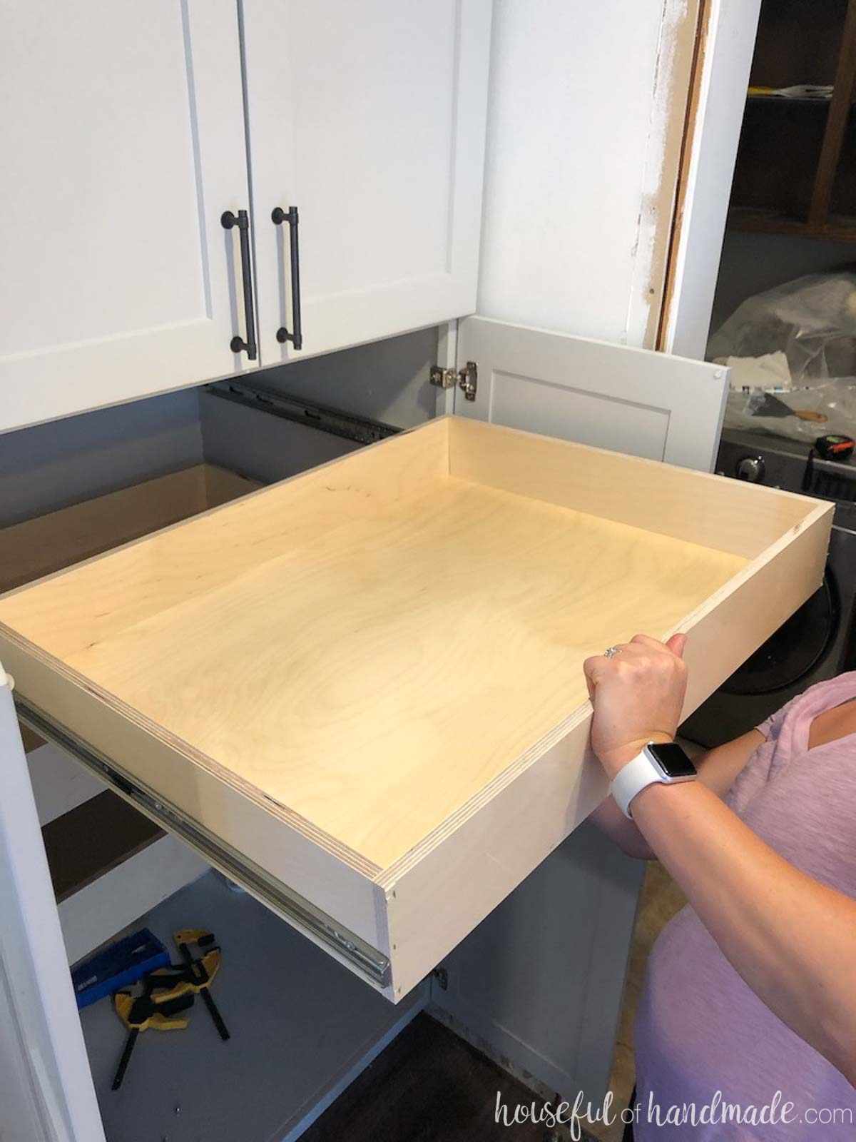 Sliding a drawer onto the drawer slides in the pantry. 