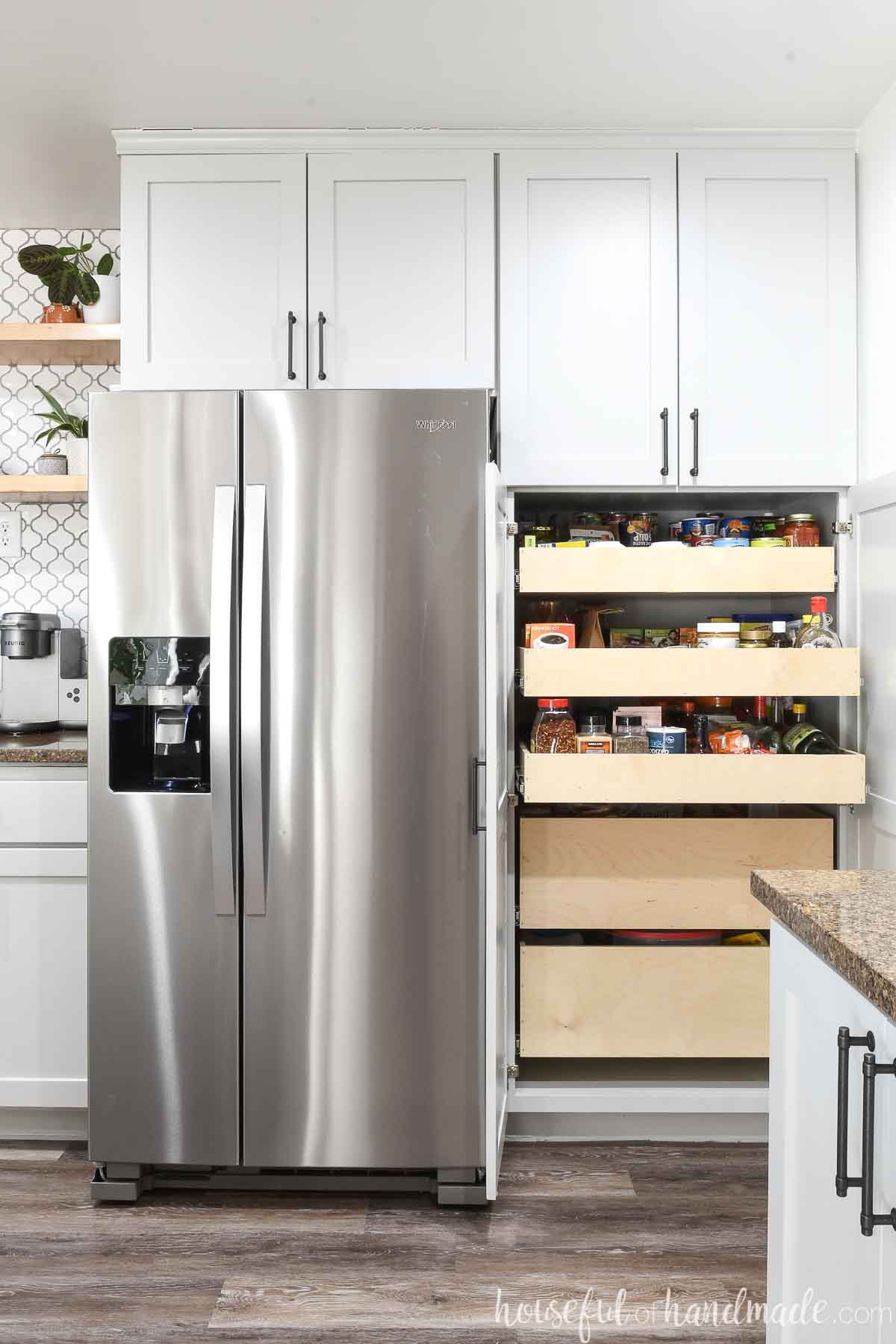 Pantry next to a fridge with 2 doors open showing the DIY pull out drawers inside.
