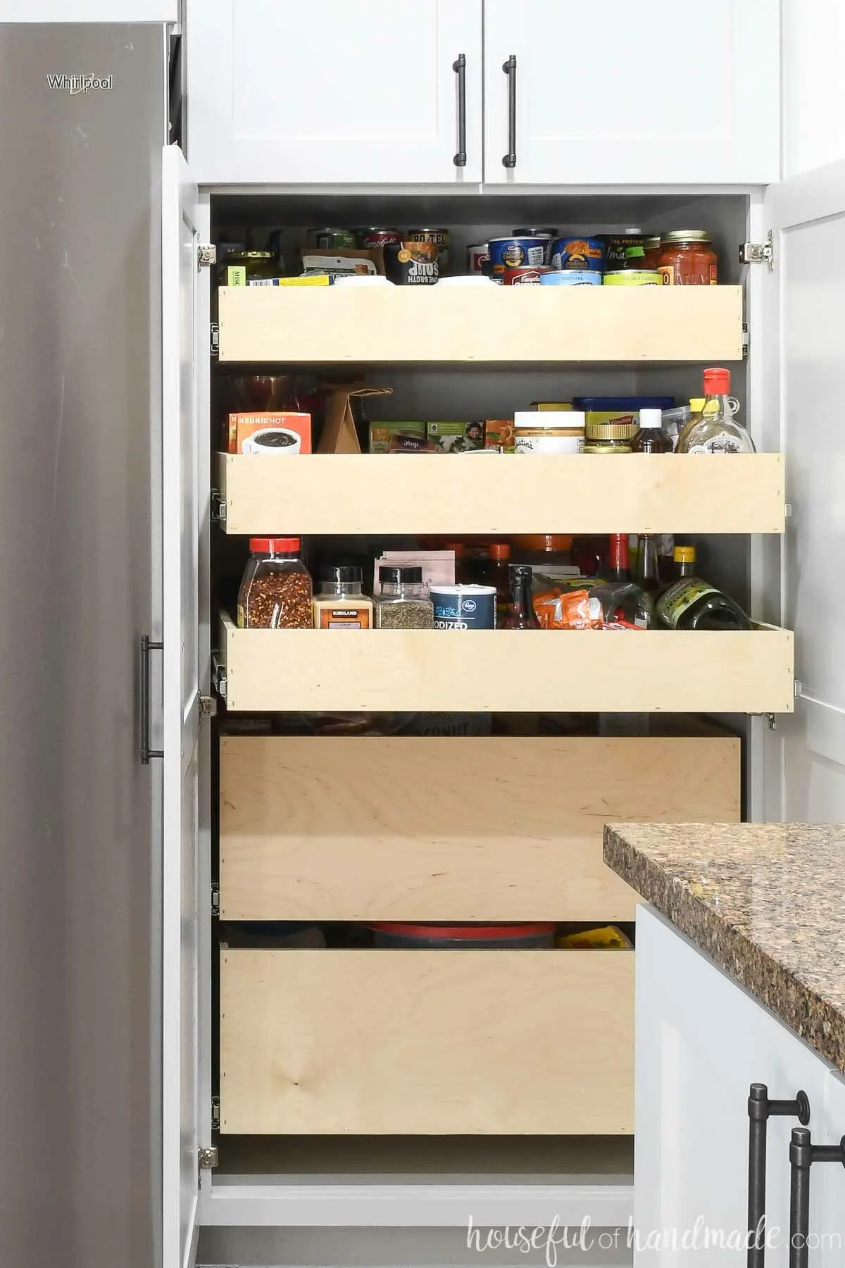 Three shallow pantry drawers above 2 deep pantry drawers in a 2 door pantry cabinet. 