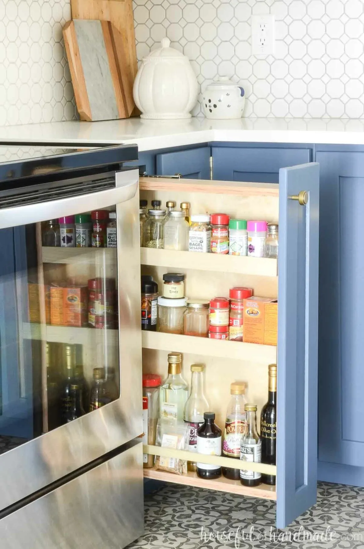 Pull out spice rack cabinet next to a stove.