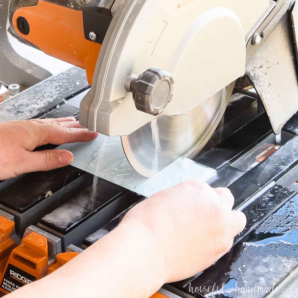 Cutting a glass tile on a tile saw. 