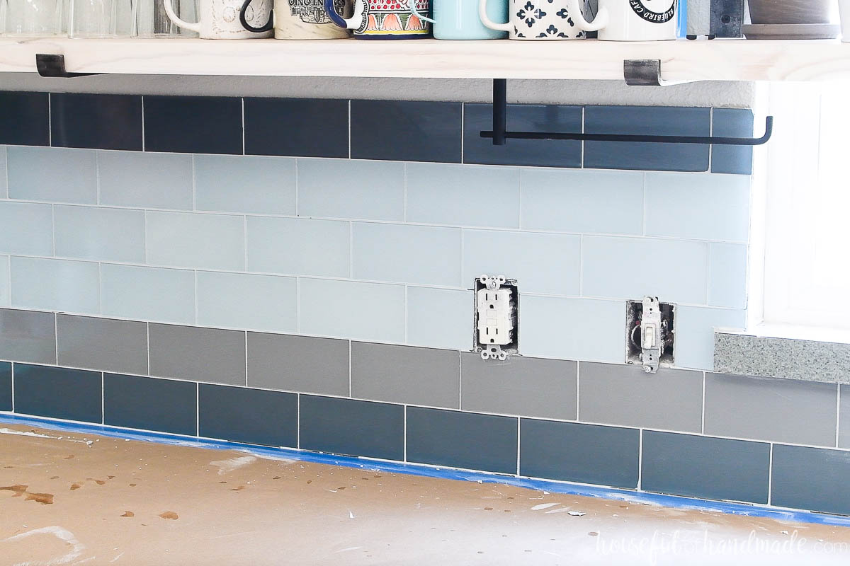 Blue and gray glass tile with white grout after removing the haze. 