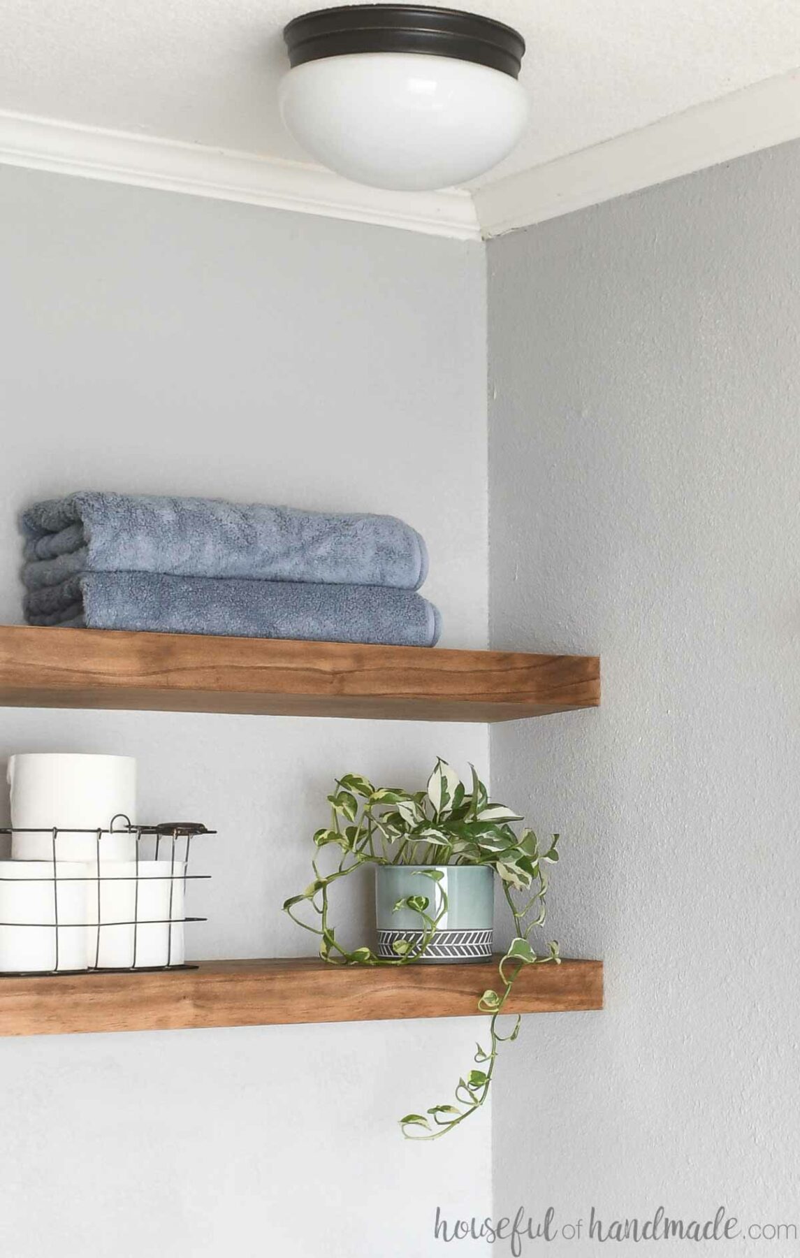 Two medium wood floating shelves in a nook.
