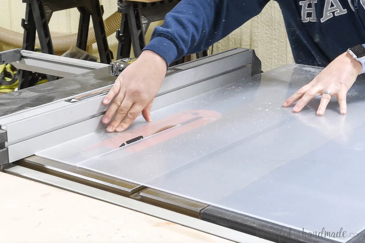 Cutting a piece of plexiglass on a table saw. 