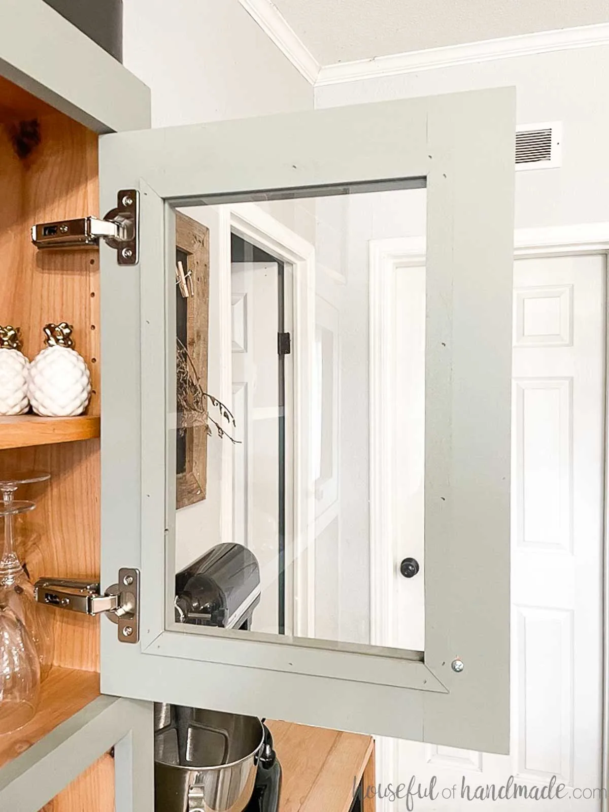 The inside of the plexiglass door in a hutch with small trim hiding the glass edges. 