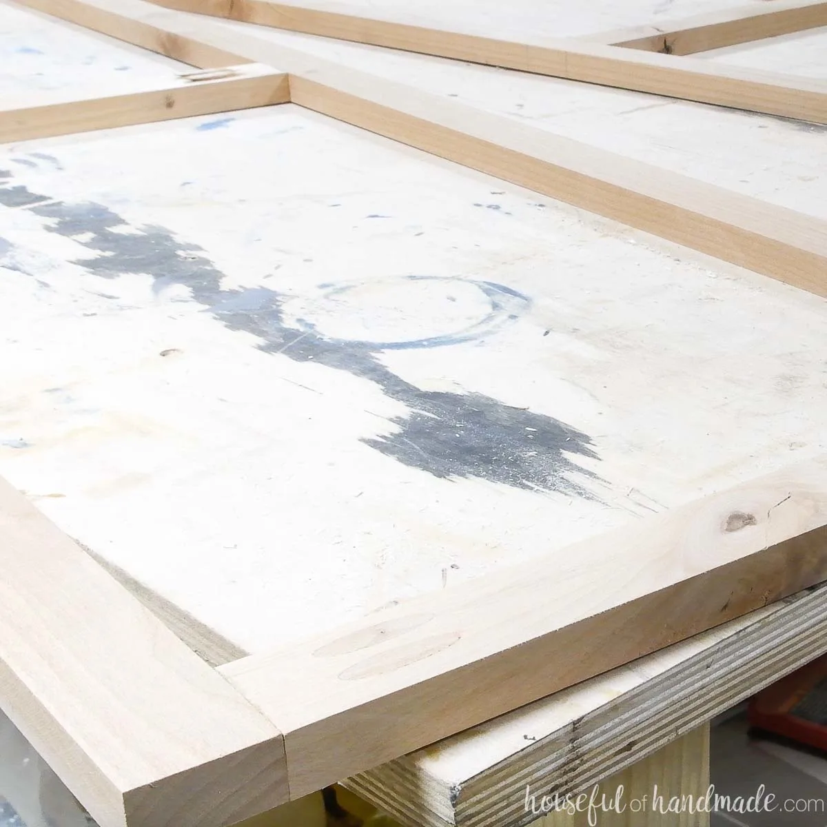 Close up of the cabinet door frame with pocket holes hidden with plugs. 